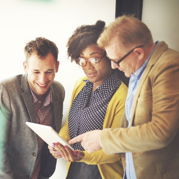 Three human resources professionals talking about a project