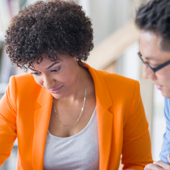 African American business woman talking with an Asian business man