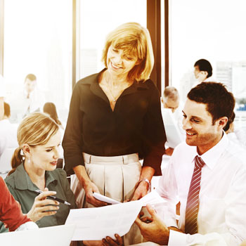 Three human resources professionals working together in a busy office