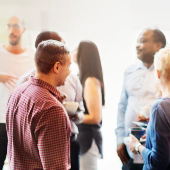 Business folk gathered in conversation